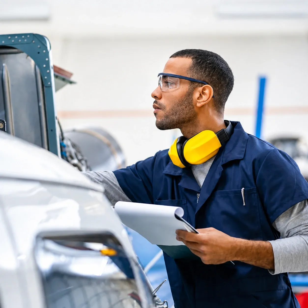 Cadillac mechanic in navy uniform performing route inspection